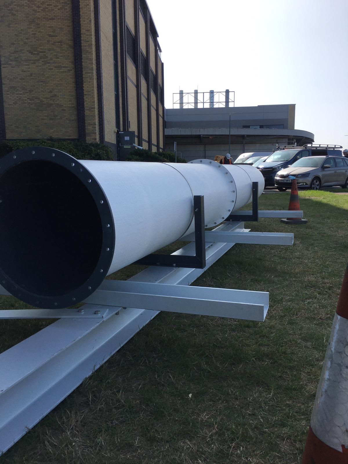 600dia White GRP coated duct about to be loaded on to roof at a large pharmaceutical laboratory in Kent